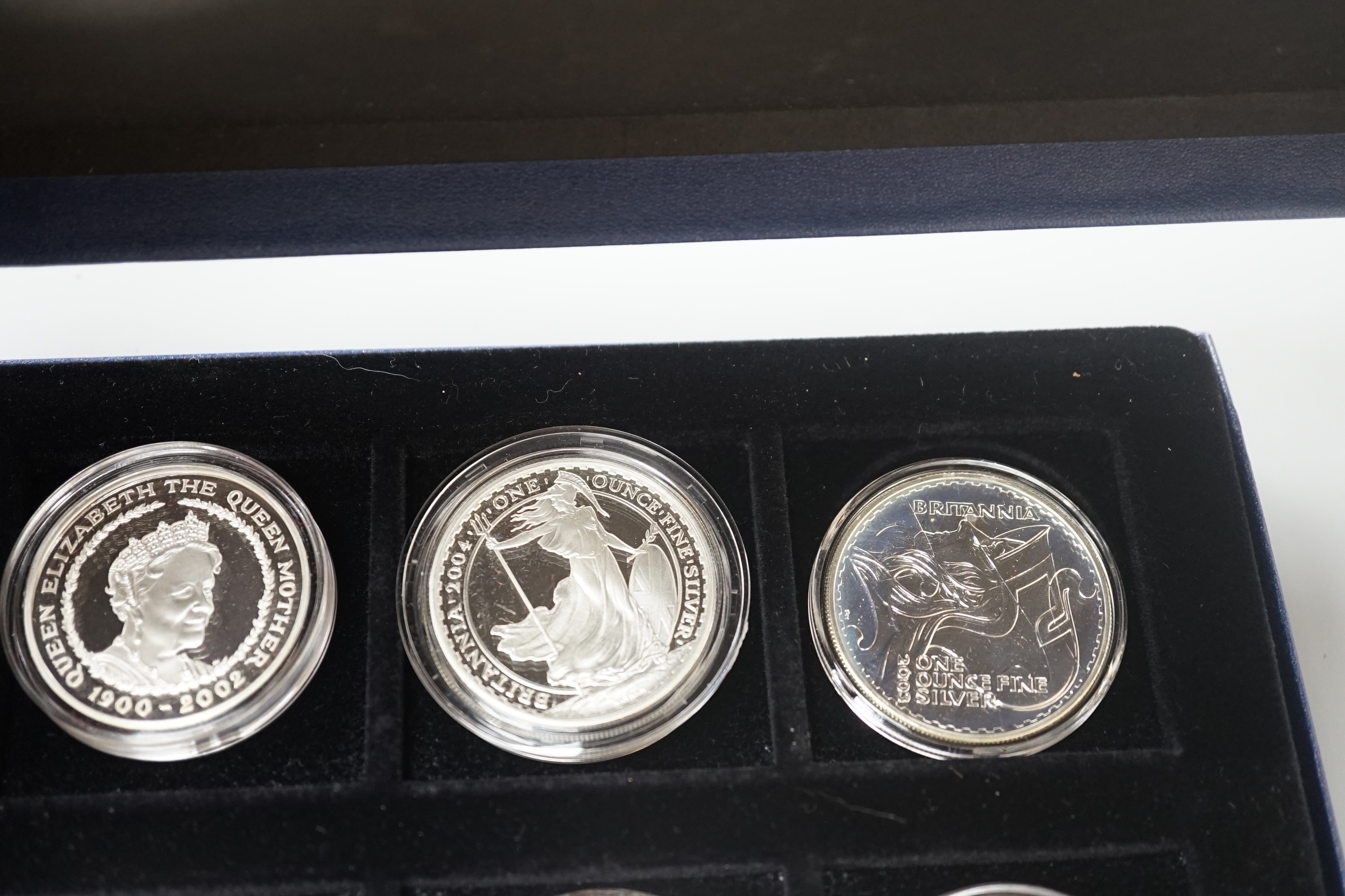 A group of coins including 1898 British Trade One Dollar, Royal Mint UK two QEII five shillings, 1935 crown, 1890 crown, silver proof coins - five 1oz. silver Britannia £2 coins 1998-2000, 2003, 2004, 2002 Queen Mother £